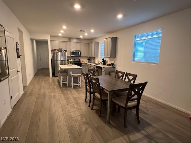 dining space with hardwood / wood-style flooring