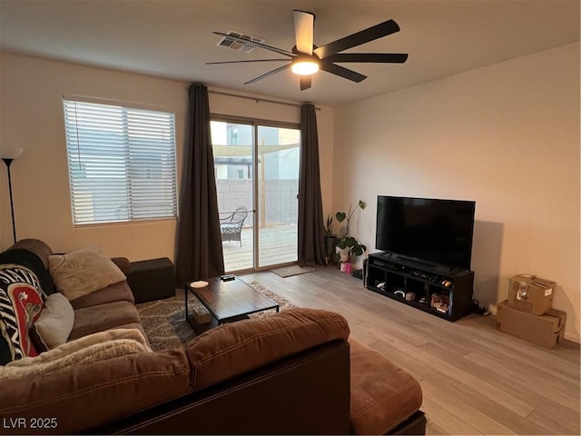 living room featuring ceiling fan and light hardwood / wood-style floors