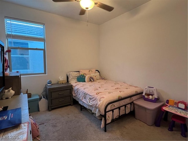 bedroom with multiple windows, ceiling fan, and light carpet