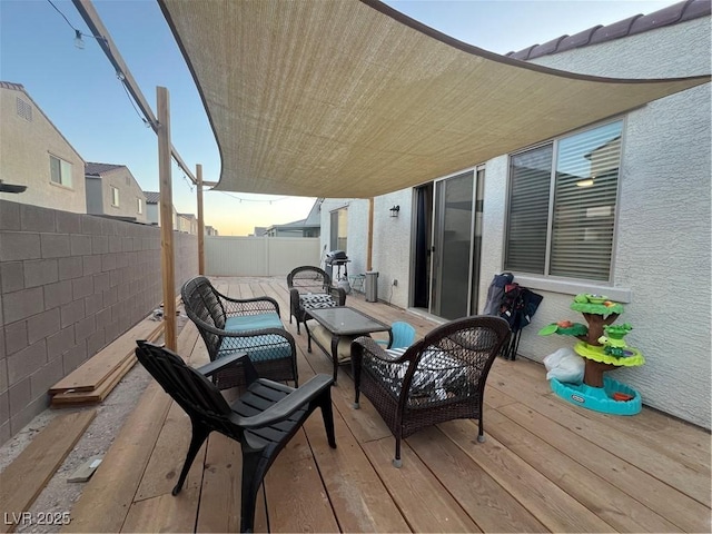 deck at dusk with an outdoor hangout area