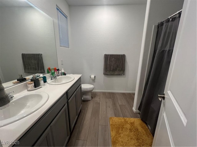 bathroom with vanity, hardwood / wood-style floors, and toilet