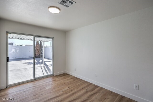 unfurnished room featuring light hardwood / wood-style flooring