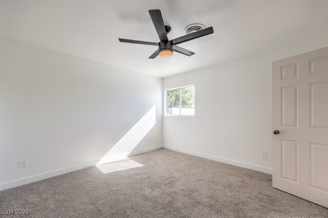 empty room featuring light colored carpet and ceiling fan