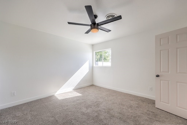 spare room featuring a ceiling fan, baseboards, and light carpet