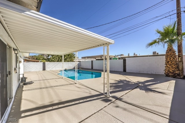 view of swimming pool with a patio area, a fenced in pool, and a fenced backyard