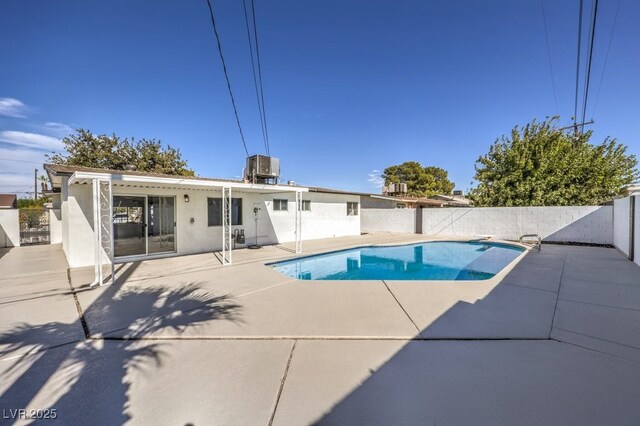 view of pool featuring cooling unit and a patio area