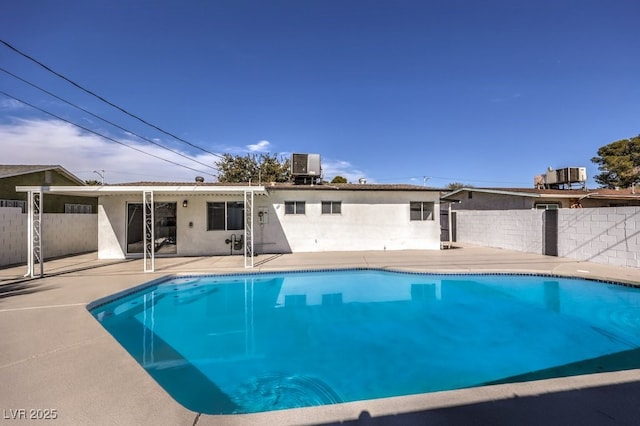 view of swimming pool with cooling unit, a patio, a fenced in pool, and fence