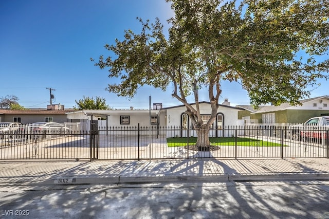 view of front of home featuring a fenced front yard and stucco siding