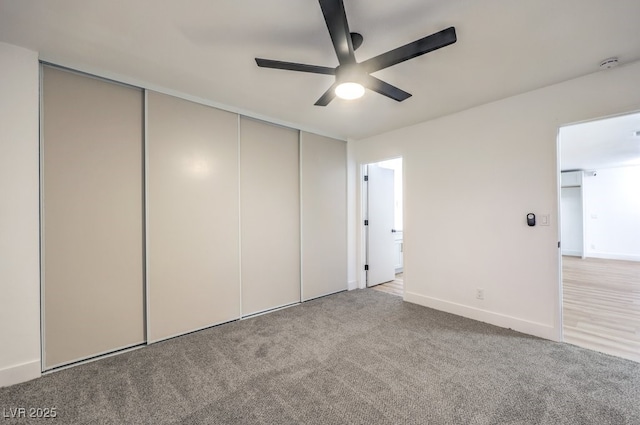 unfurnished bedroom featuring ceiling fan, carpet flooring, and a closet