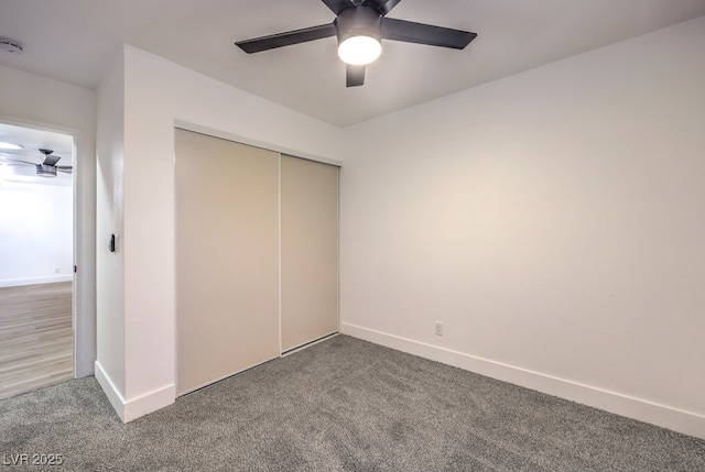 unfurnished bedroom featuring carpet, ceiling fan, and a closet