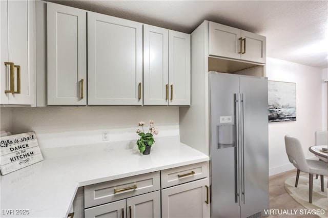 kitchen featuring gray cabinetry and stainless steel fridge