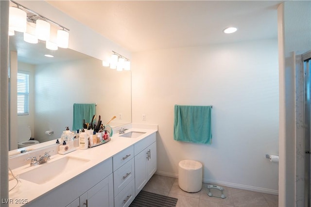 bathroom with tile patterned floors and vanity