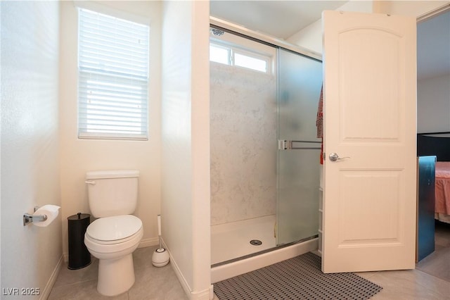 bathroom with a shower with door, tile patterned floors, and toilet