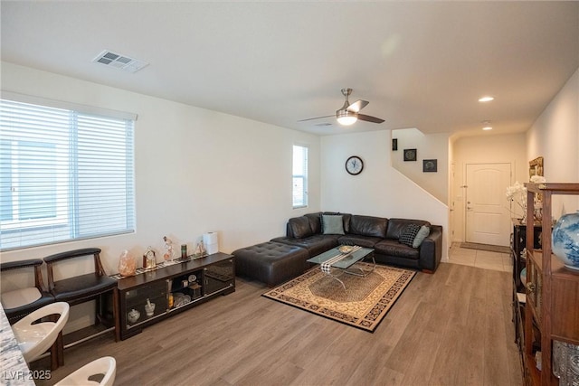 living room with ceiling fan and light hardwood / wood-style flooring