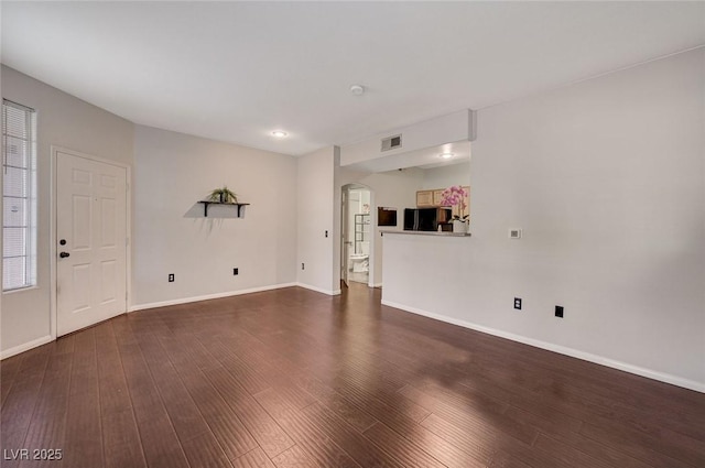 unfurnished living room featuring dark hardwood / wood-style flooring