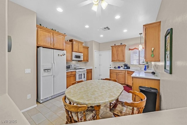 kitchen featuring sink, white appliances, decorative light fixtures, and ceiling fan