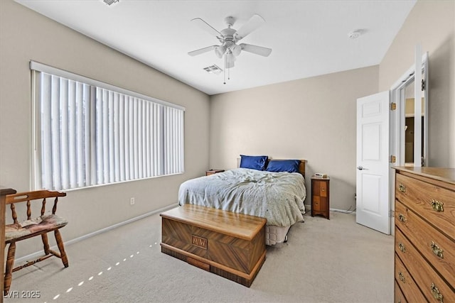 bedroom with ceiling fan and light carpet