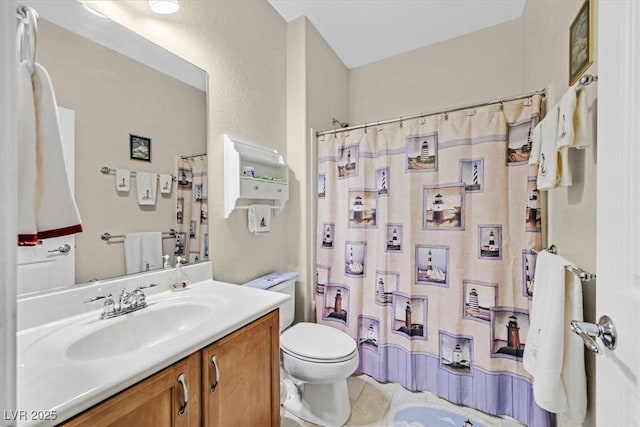 bathroom with a shower with curtain, vanity, tile patterned floors, and toilet