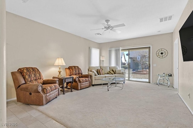 living room featuring light carpet and ceiling fan