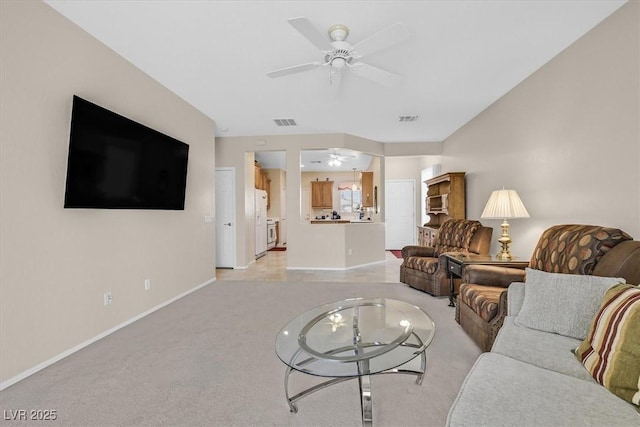 living room with light carpet and ceiling fan