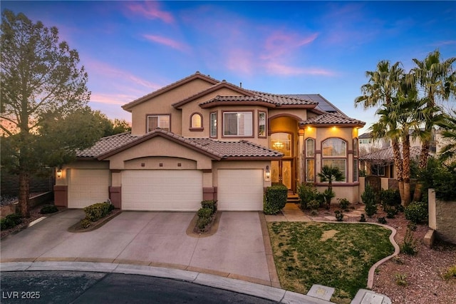 mediterranean / spanish house with a garage