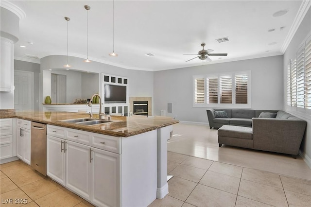 kitchen featuring sink, decorative light fixtures, light tile patterned floors, and white cabinets