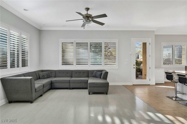 living room with ceiling fan and ornamental molding