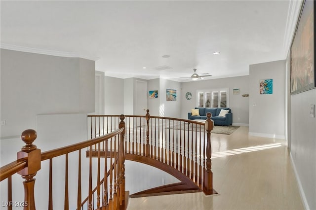 corridor with hardwood / wood-style flooring and crown molding