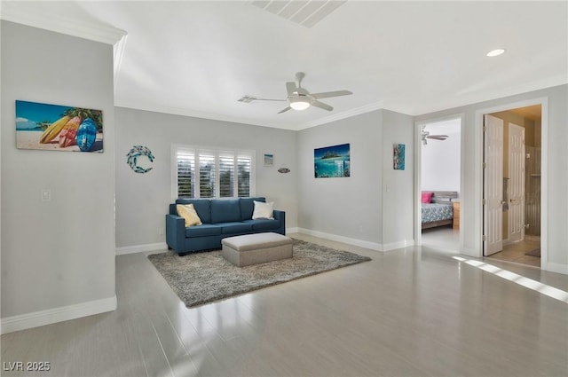 living room with ceiling fan, ornamental molding, and light hardwood / wood-style flooring