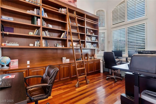 office featuring hardwood / wood-style flooring and a high ceiling