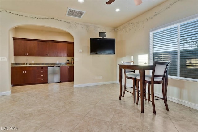 kitchen with sink, light tile patterned floors, fridge, dishwasher, and ceiling fan