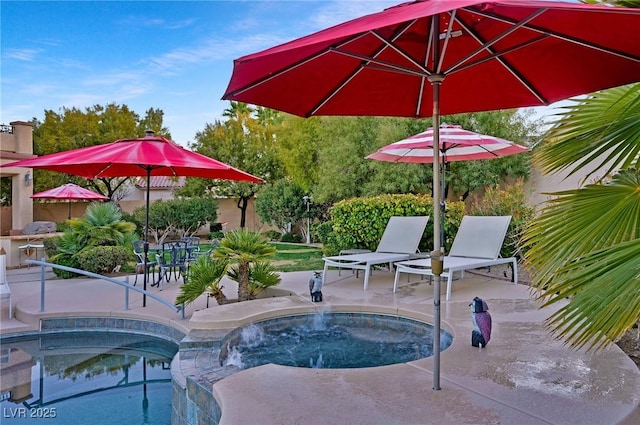 view of swimming pool featuring an in ground hot tub and a patio area