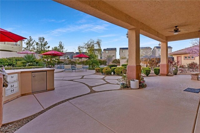 view of patio / terrace with ceiling fan and an outdoor kitchen