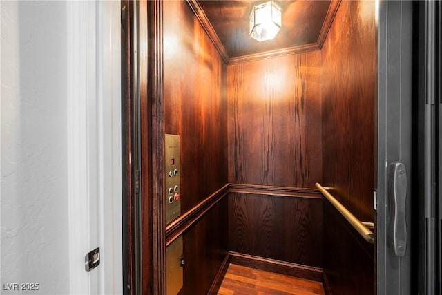 room details with crown molding, wood-type flooring, and elevator