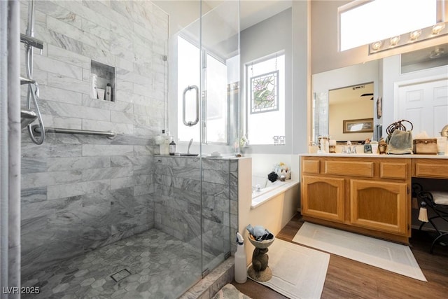 bathroom featuring vanity, hardwood / wood-style floors, and a shower with shower door