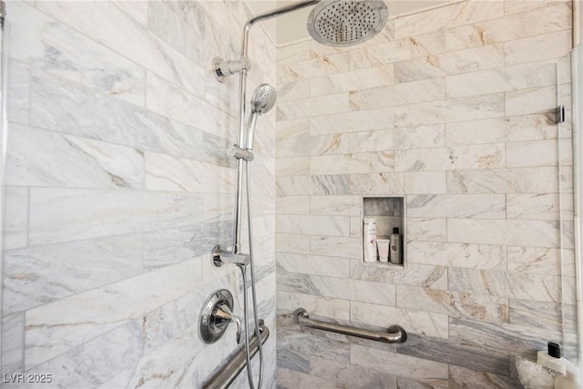 bathroom with a tile shower