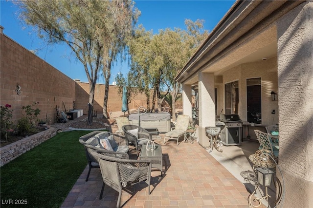 view of patio / terrace featuring area for grilling and a hot tub