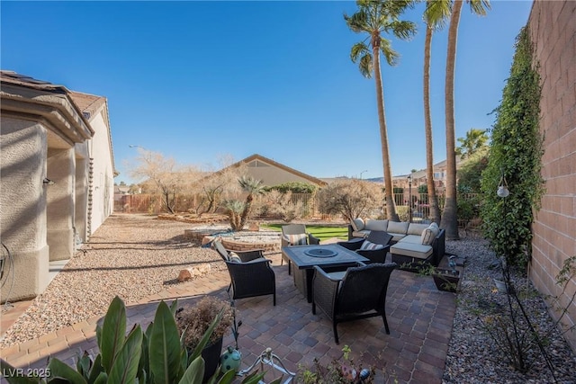 view of patio with an outdoor living space with a fire pit