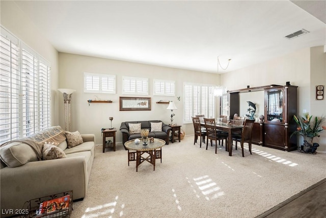 carpeted living room with a healthy amount of sunlight