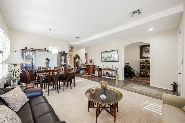 living room featuring an inviting chandelier and hardwood / wood-style flooring