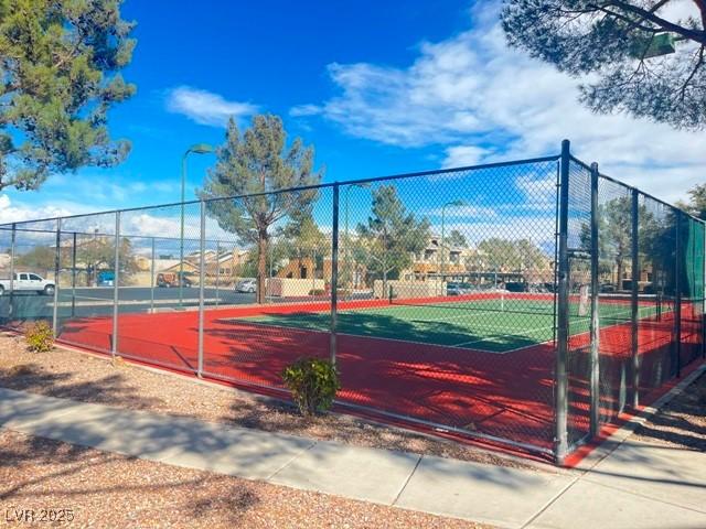 view of tennis court with fence