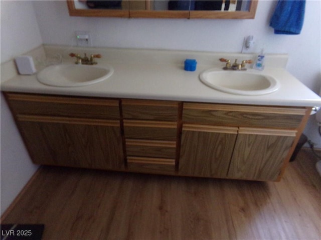 bathroom featuring vanity, wood-type flooring, and toilet