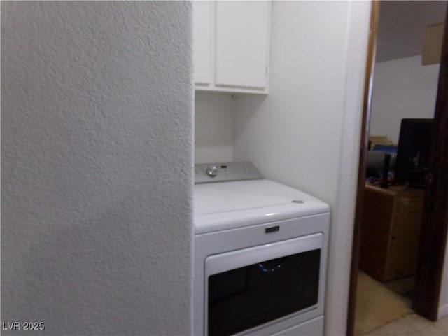 laundry area with washer / dryer and cabinets