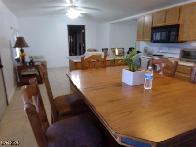 tiled dining area with ceiling fan