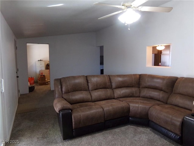 living room with ceiling fan, vaulted ceiling, and carpet