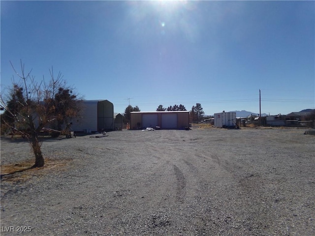 exterior space featuring a garage and an outbuilding