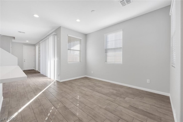 spare room featuring wood-type flooring