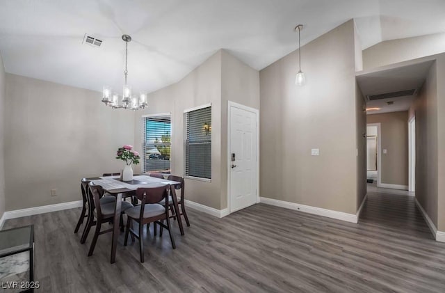 dining room featuring a notable chandelier, high vaulted ceiling, and dark hardwood / wood-style floors