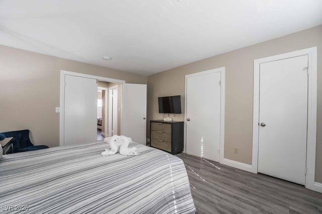 bedroom with dark hardwood / wood-style flooring