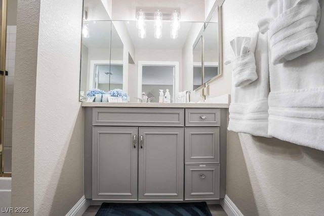 bathroom with enclosed tub / shower combo and vanity